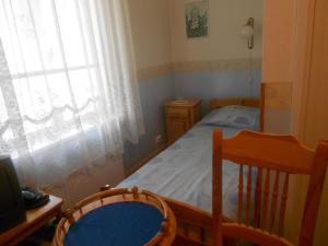 a small bedroom with a bed and a window at Poska Villa Guesthouse in Tallinn