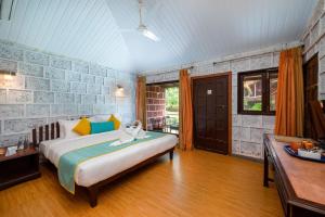 a bedroom with a bed in a room at Lotus an Eco Beach Resort Dapoli Murud in Dapoli