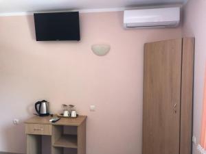 a room with a television and a wooden cabinet at Guest House Rest in Sapareva Banya