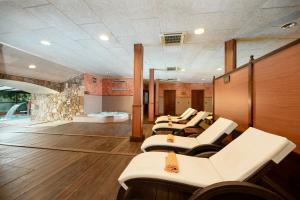 a row of white chairs in a waiting room at Rigat Park & Spa Hotel - Adults Recommended in Lloret de Mar