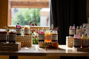 a table with jars of jam and oranges on it at Le Grand Aigle Hotel & Spa**** in La Salle-les-Alpes