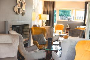 a living room with chairs and a fireplace at Le Grand Aigle Hotel & Spa**** in La Salle-les-Alpes