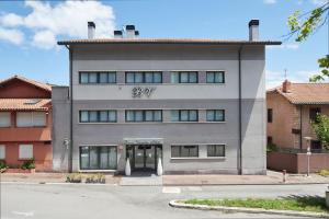 a gray building with the number on it at Hotel Berri Versalles in Rentería