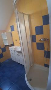a bathroom with a shower and a sink at Ravnice Rooms and Apartments in Zagreb