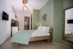 a bedroom with a large bed and a mirror at Gio Apartments in Preveza