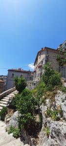 a building sitting on top of a rocky hill at B&B CasaCaselle in Caselle in Pittari