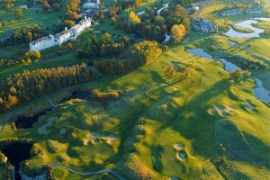 an aerial view of a golf course with a river at The K Club in Straffan