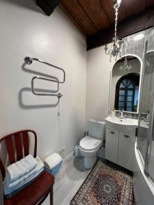 a bathroom with a toilet and a sink and a mirror at Tiltų 5 Apartment in Klaipėda