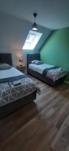 a bedroom with two beds and a light on the ceiling at Gites Ostheim in Ostheim