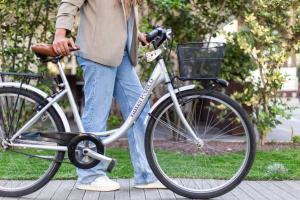 una donna che cammina in bicicletta su un marciapiede di Hotel Parco a Milano Marittima