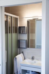 a bathroom with a sink and a mirror at Hotel La Casa in Le Barcarès