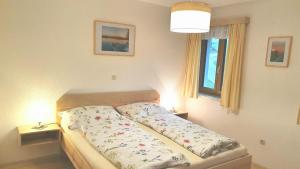 a bed in a bedroom with two lamps on tables at Mitterhirschberg, Familie Schweighuber in Waidhofen an der Ybbs +22 photos