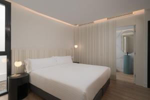 A bed or beds in a room at Boutique Hotel Cordial La Niña de Vegueta