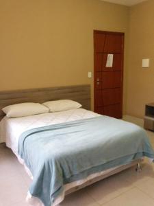 Postel nebo postele na pokoji v ubytování Conquista Palace Hotel