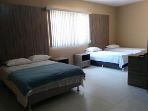 Postel nebo postele na pokoji v ubytování Conquista Palace Hotel + 37 fotografií