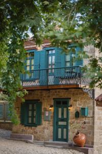 a building with a blue window and a balcony at Orion Adatepe in Adatepe