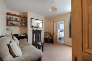a living room with a couch and a fireplace at 23 Lym Close in Lyme Regis