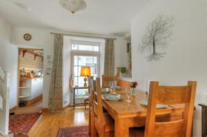 una sala da pranzo con tavolo e sedie in legno di Windwhistle a Lyme Regis