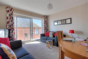 a living room with a couch and a table at 4 Bay View Court in Lyme Regis