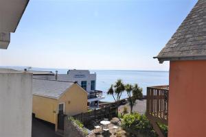 a view of the ocean from a balcony of a building at 4 Bay View Court in Lyme Regis