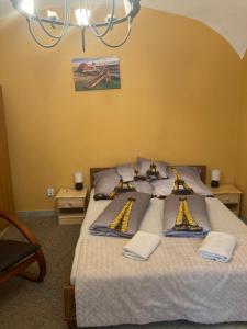 um quarto com uma cama grande e toalhas em Gabriella Apartman em Eger