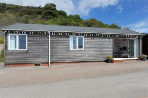 a small house with a porch at The Beach Hut in Lyme Regis