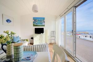 a living room with a view of the ocean at The Beach Hut in Lyme Regis