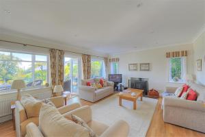 a living room with couches and a fireplace at Somerhill in Lyme Regis