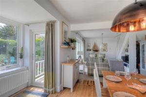 a kitchen and living room with a table and a dining room at Highpoint Lodge in Lyme Regis