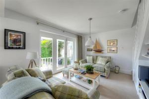 a living room with a couch and a table at Highpoint Lodge in Lyme Regis