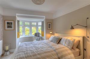a bedroom with a bed and a window at Highpoint Lodge in Lyme Regis