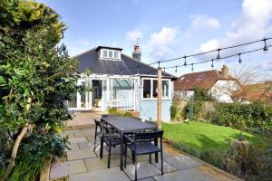 a patio with a table and chairs in a yard at Highpoint Lodge in Lyme Regis