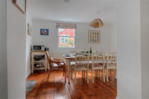 a dining room with a table and chairs at Hamilton House in Lyme Regis