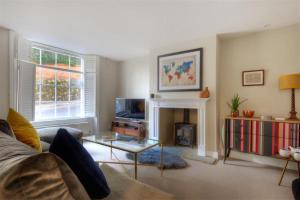 a living room with a couch and a fireplace at The Lodge in Lyme Regis