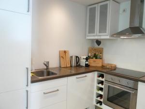 a kitchen with white cabinets and a sink at Forsthof Waldblick Karow in Karow