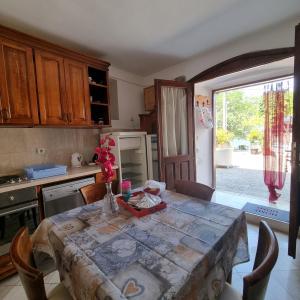 a kitchen with a table with chairs and an open door at Apartment Jovan2,on the beach with free Wi-Fi in Kotor