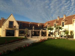 a large house with a lawn in front of it at Auberge du Moulin à Vent, The Originals Relais (Relais du Silence) in Manou