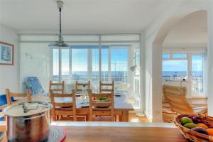 a kitchen and dining room with a table and chairs at 9 The Old Shipyard in West Bay