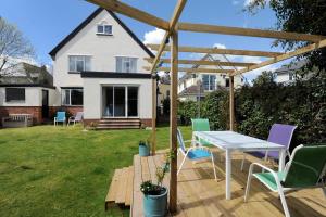 a patio with a table and chairs in a yard at 2 Grange Villas in Charmouth