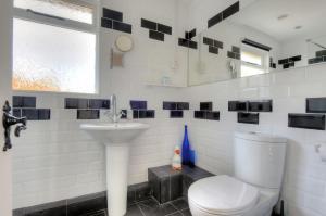 a bathroom with a toilet and a sink at Dolphins Leap in Charmouth +16 photos
