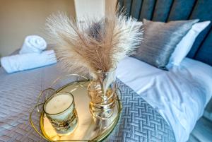 a glass table with a vase on top of a bed at Modern 5 bed house In Solihull, Close to the NEC, Airport and Solihull Town - Parking in Solihull +38 photos