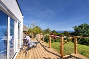 a deck with two chairs and a view of the ocean at Lottys Lookout in Lyme Regis