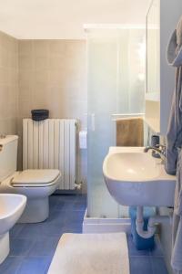 a bathroom with a sink and a toilet and a shower at Villetta stile Liberty a Marina di Pisa in Marina di Pisa
