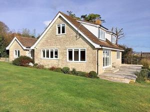 a large brick house with a green lawn at Pendower in Charmouth +12 photos