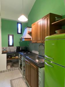 a kitchen with a green refrigerator and a sink at Villa Venere Apartment in Realmonte