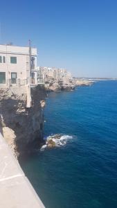 an aerial view of the ocean with a building at dimora cieli di dante 17 in Polignano a Mare