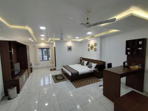 a living room with a bed and a desk at Firefly Resort in Kanthalloor