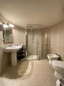 a bathroom with a shower and a sink and a toilet at Villa Venere Apartment in Realmonte