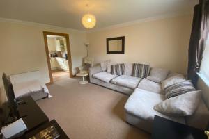 a living room with a couch and a table at Carn Avie House in Aviemore