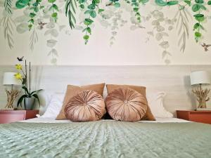 a bedroom with a bed with two pillows on it at TraMonti Apartments in Poggio Picenze